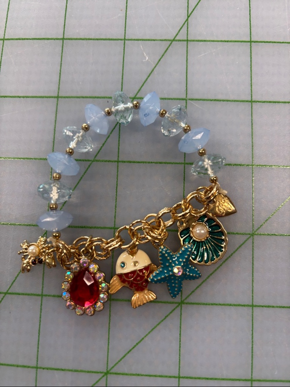 Gold Charm Bracelet with Light Blue Beads and Ocean Charms